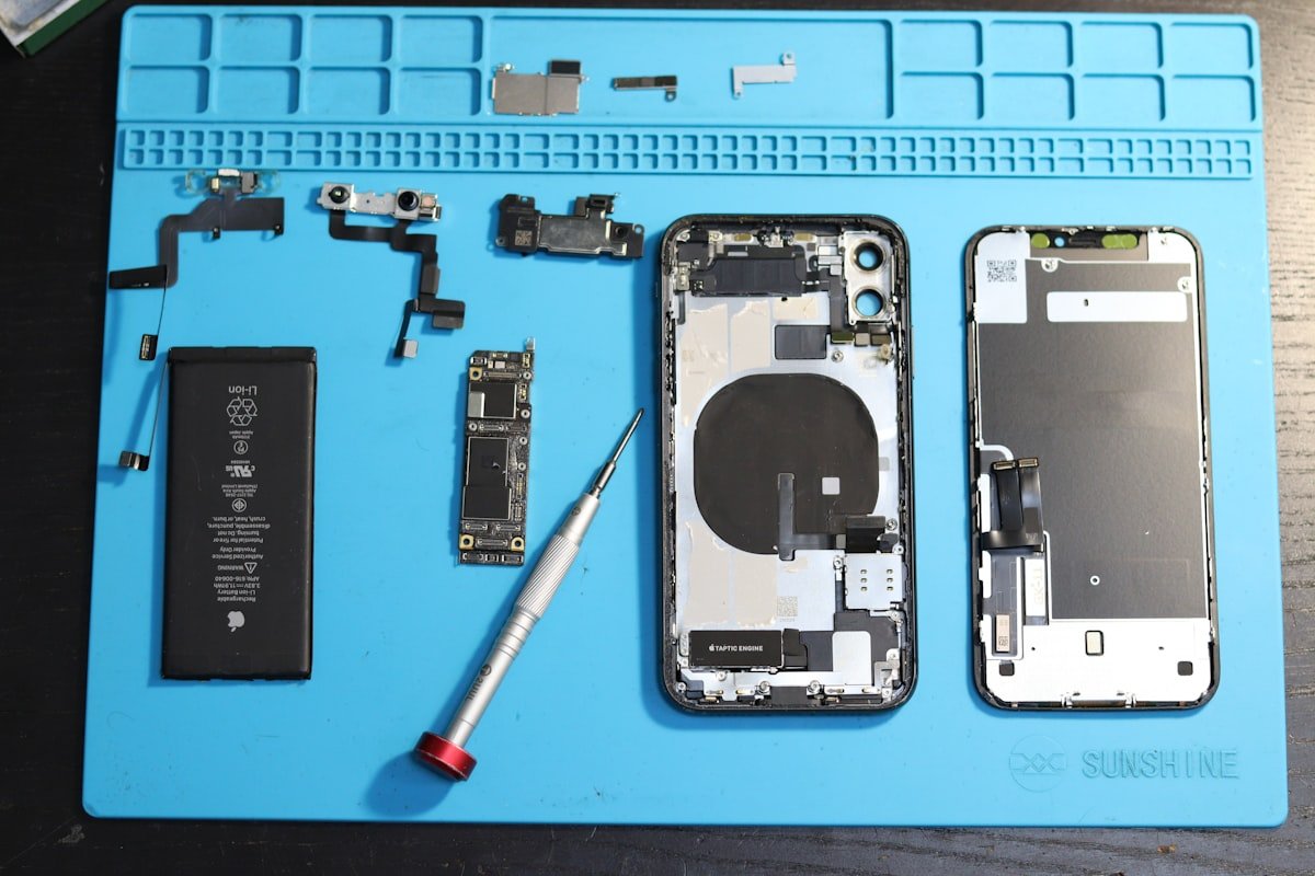 Disassembled smartphone parts on a repair bench